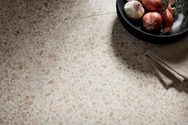 Brown speckled terrazzo tile with shallot bowl