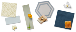 Assorted tiles in varied shapes, colors, and surface textures with a floral, soaps, and honeycomb accents.