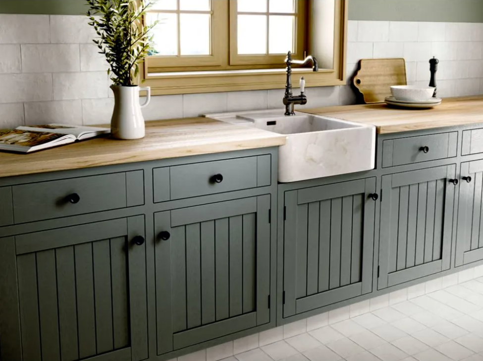 Kitchen sink and cupboards with a white tile backsplash