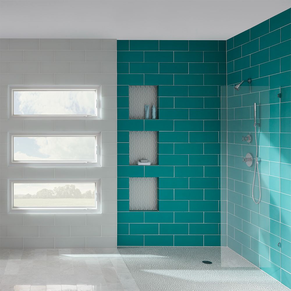 subway tile shower with teal blue tiles and white walls