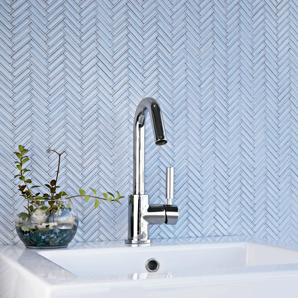 light blue glass herringbone subway tile bathroom backsplash