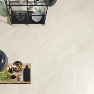 A top down view of pale white stone tiles flooring a kitchen