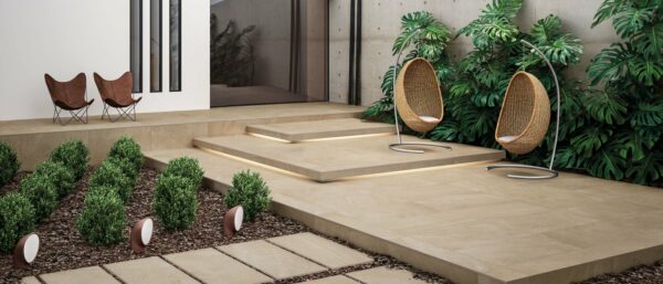 The rear patio of a home with a walking path