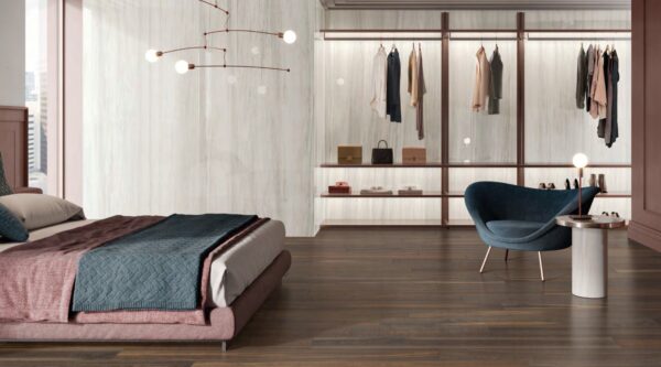 A bedroom with stone tiled walls and wooden flooring