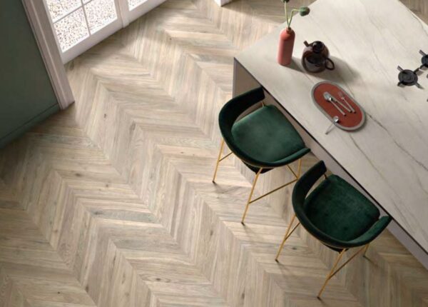 Angled wood floors under a stone dining table