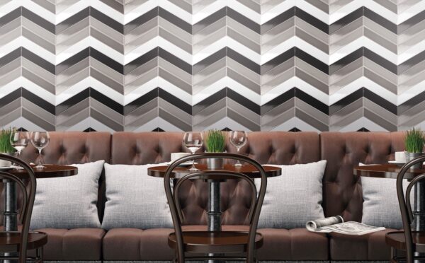 Black, white, and grey angled wall tiles behind a couch