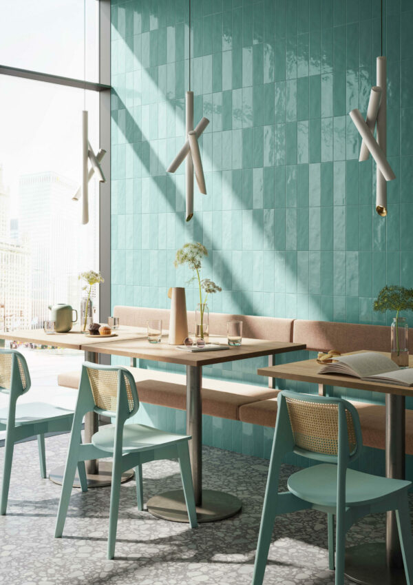 Blue stone wall tiles matching chairs at tables nearby